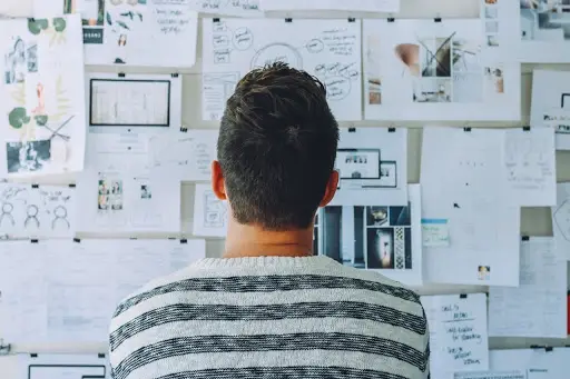 man looking at mood board